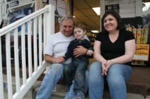 Jarrell family sitting on storefront's stairs