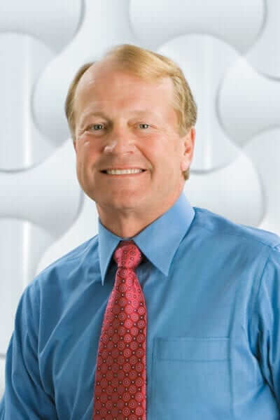 John Chambers smiling for the camera.