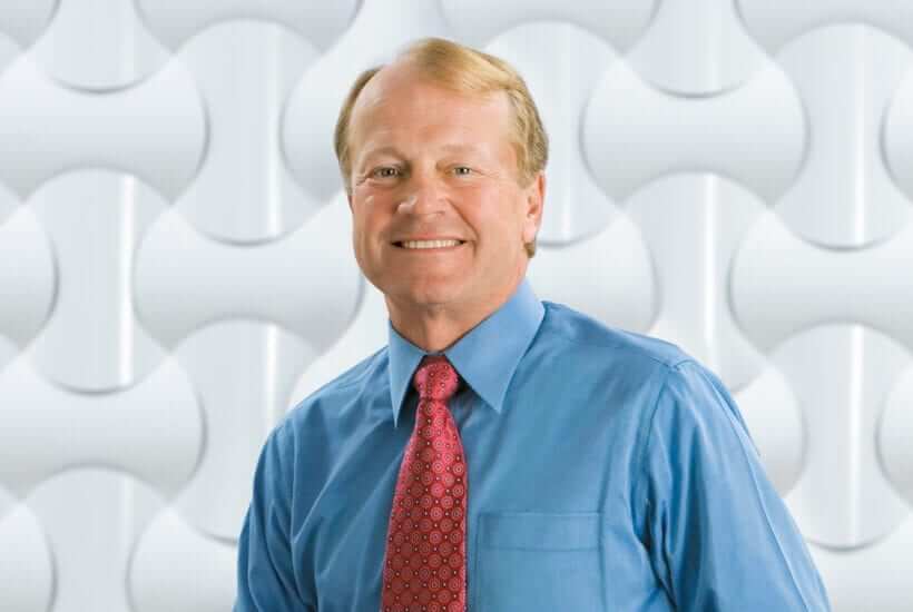 John Chambers smiling for the camera.