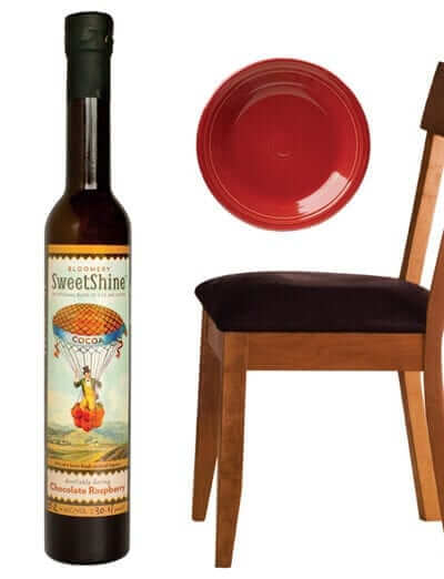 WV made products: Blue Smoke Salsa, glass blown vase, Bloomery SweetShine wine, ceramic plate, wooden chair, wooden spoon