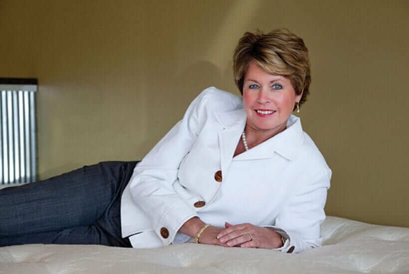 Kim Brown Knopf lounging on a mattress
