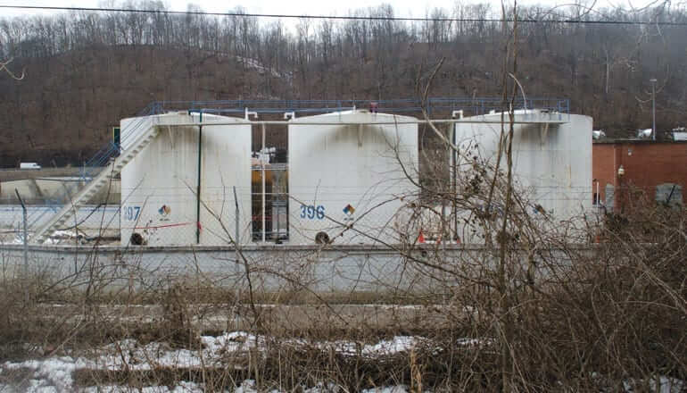 view of water tanks behind dead plants