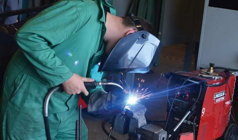 Man welding metal together